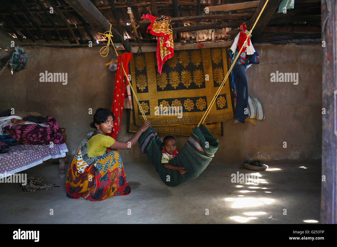 KOLAM TRIBE Traditional hammock with baby being rocked to sleep