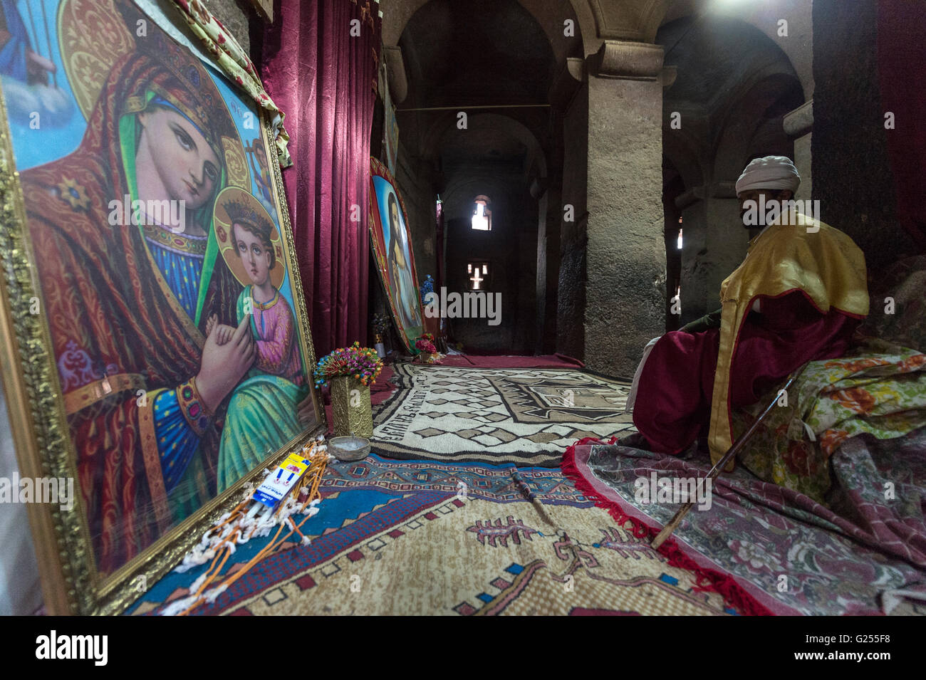 Orthodox Priest praying inside rock-cut churches Lalibela, Ethiopia ...