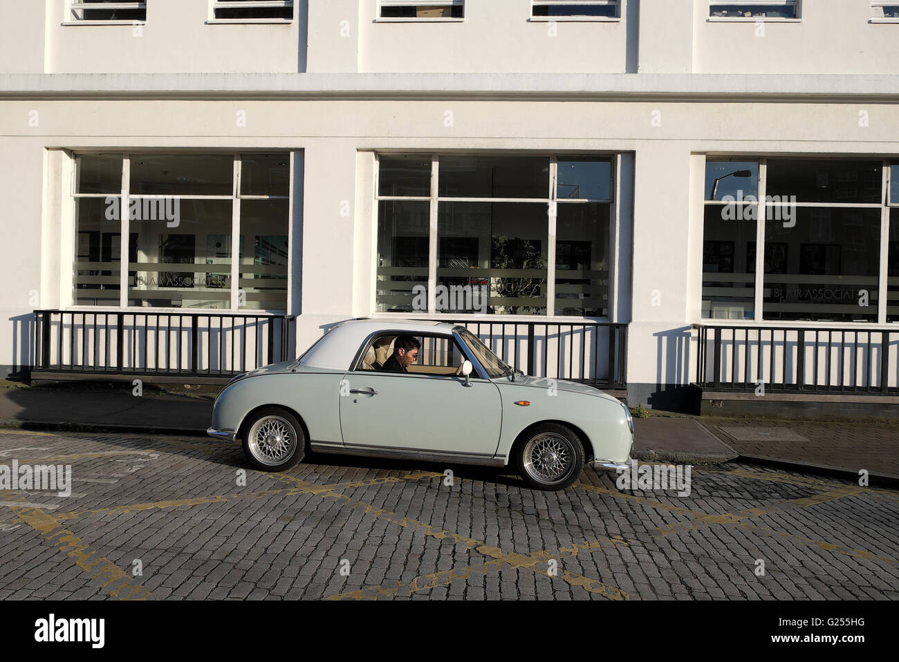 Nissan Figaro parked outside  a modern building in East London UK  KATHY DEWITT Stock Photo