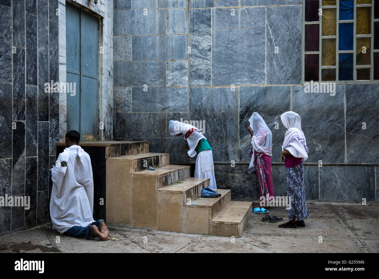 Locals praying outside the St Mary of Zion church Axum, Ethiopia Stock Photo