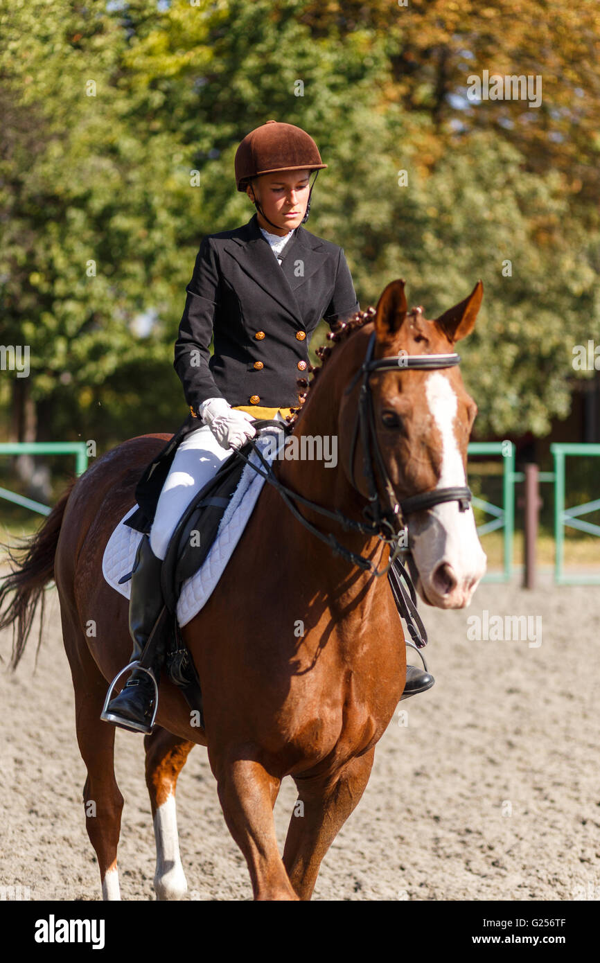 Young teenage girl riding a horse. Equestrian sportswoman jockey Stock Photo