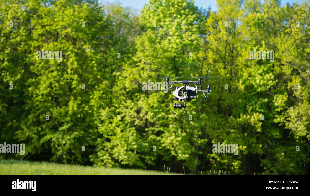 Flying drone is filming in the forest background Stock Photo - Alamy
