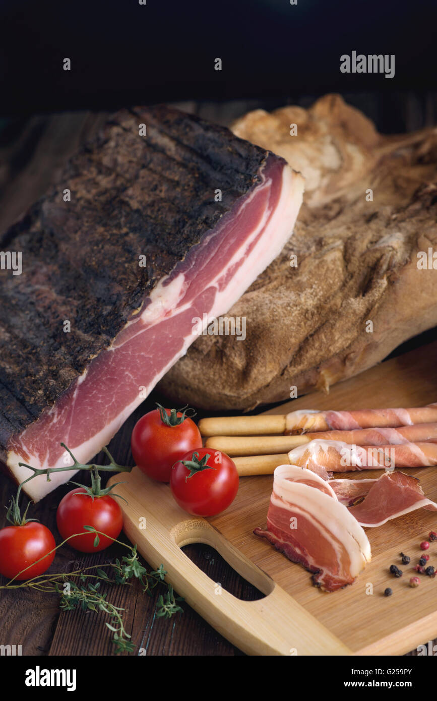 Bread, breadsticks and prosciutto with tomatoes Stock Photo