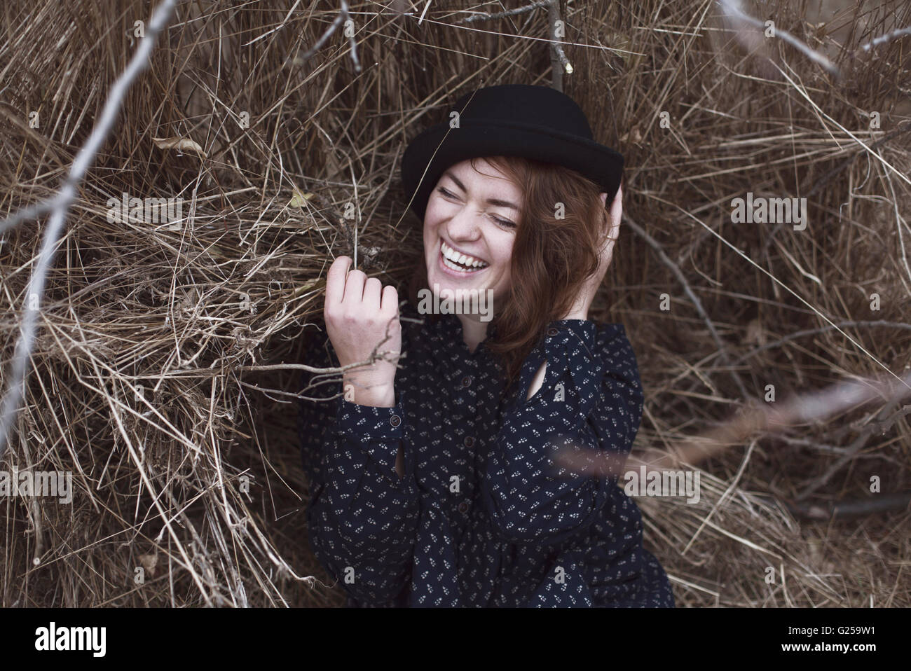 Portrait of a Laughing woman lying in grass Stock Photo