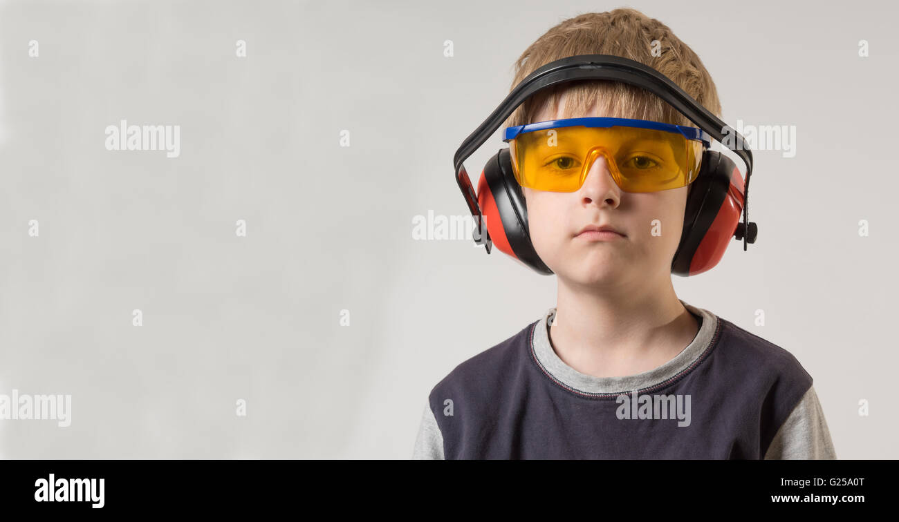 Portrait of a boy wearing safety glasses and ear defenders Stock Photo