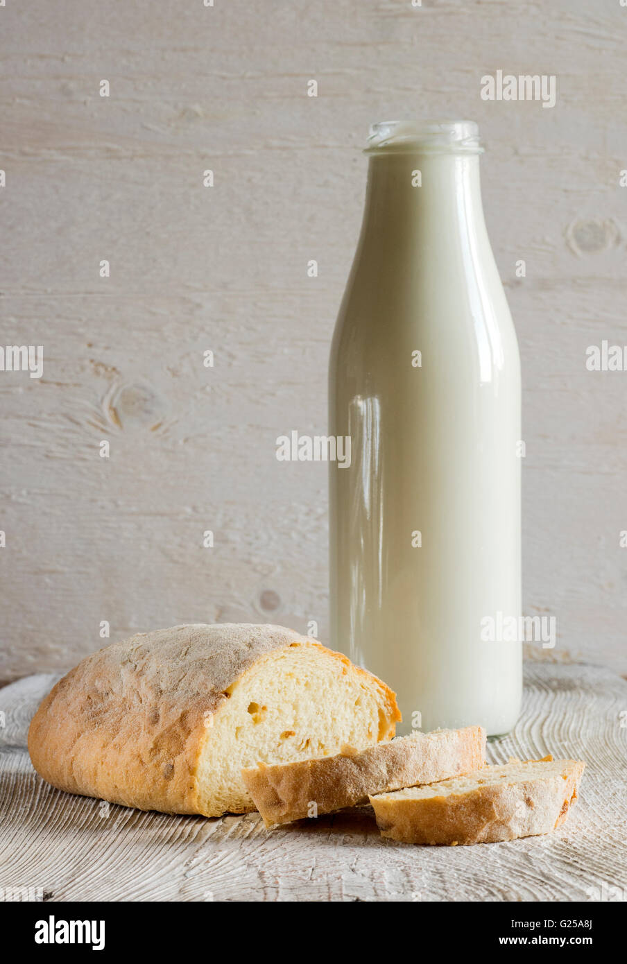 Bottle of milk and loaf of wholemeal bread Stock Photo