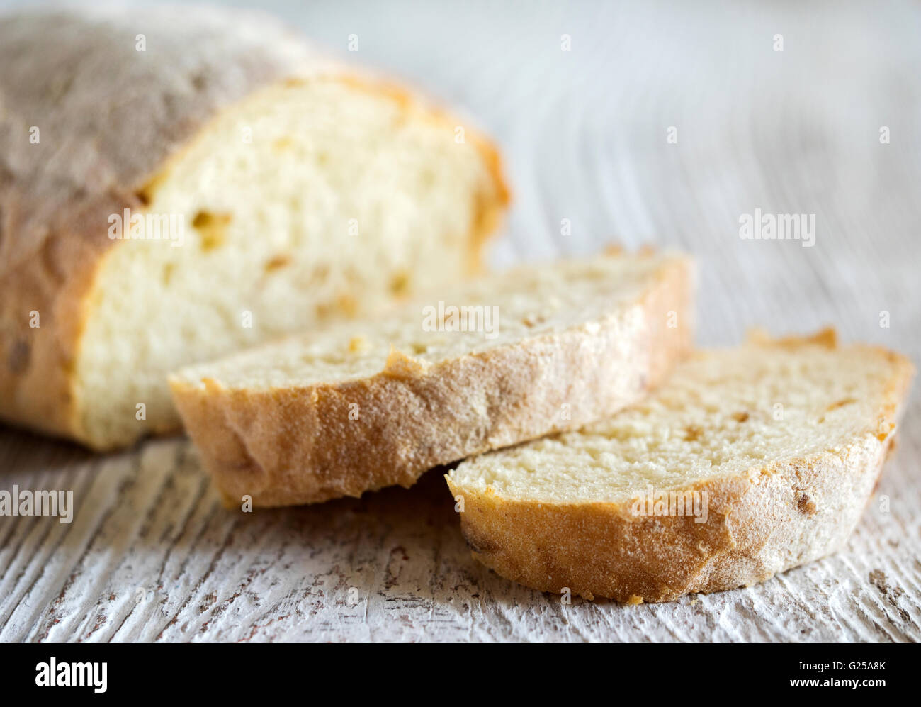 Loaf of wholemeal bread and slices of bread Stock Photo