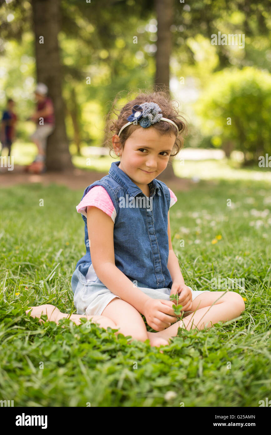 Girl sitting in park Stock Photo