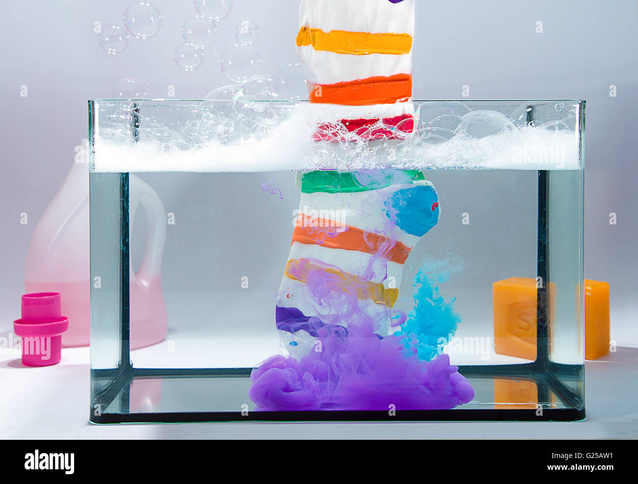 Multi-colored striped stock in tank of water with bleach Stock Photo
