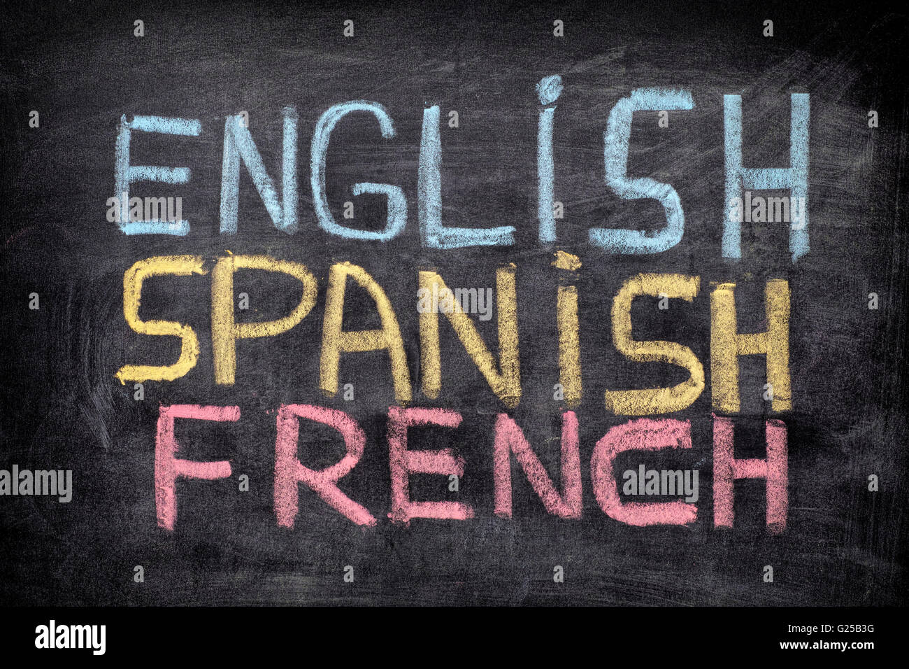 Choose your language. Words English, Spanish, French drawn on blackboard. Close up. Stock Photo