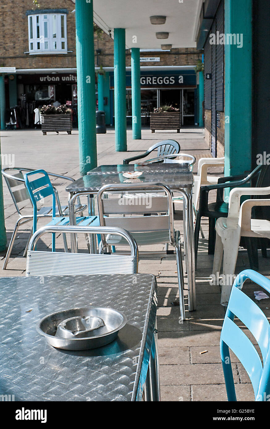 café metal tables aqua blue chairs and pillars Chrisp street market