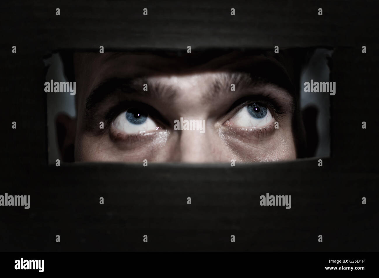 Male eyes spying through a hole in the wall Stock Photo Alamy