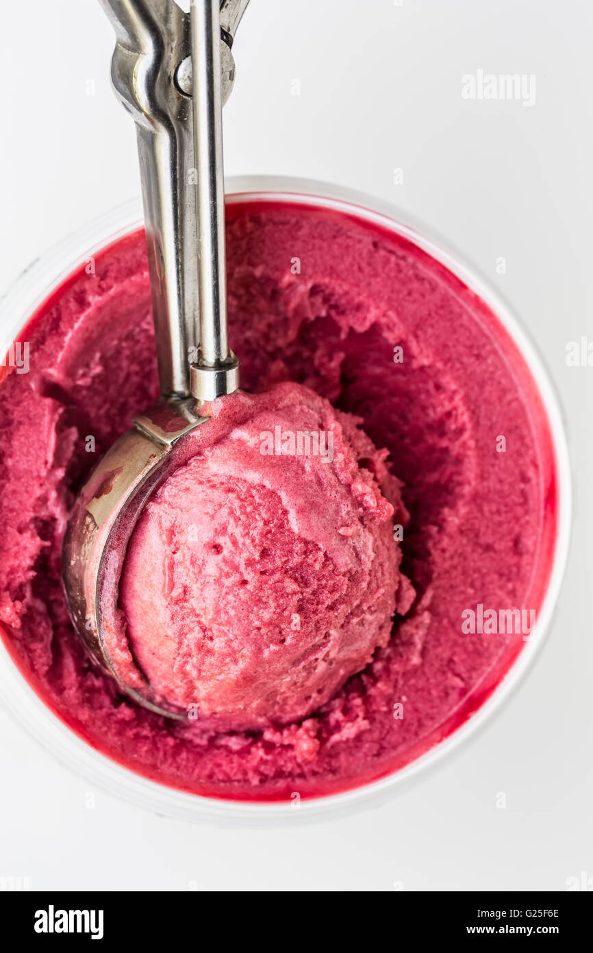 Raspberry ice cream scoop in a tin Stock Photo