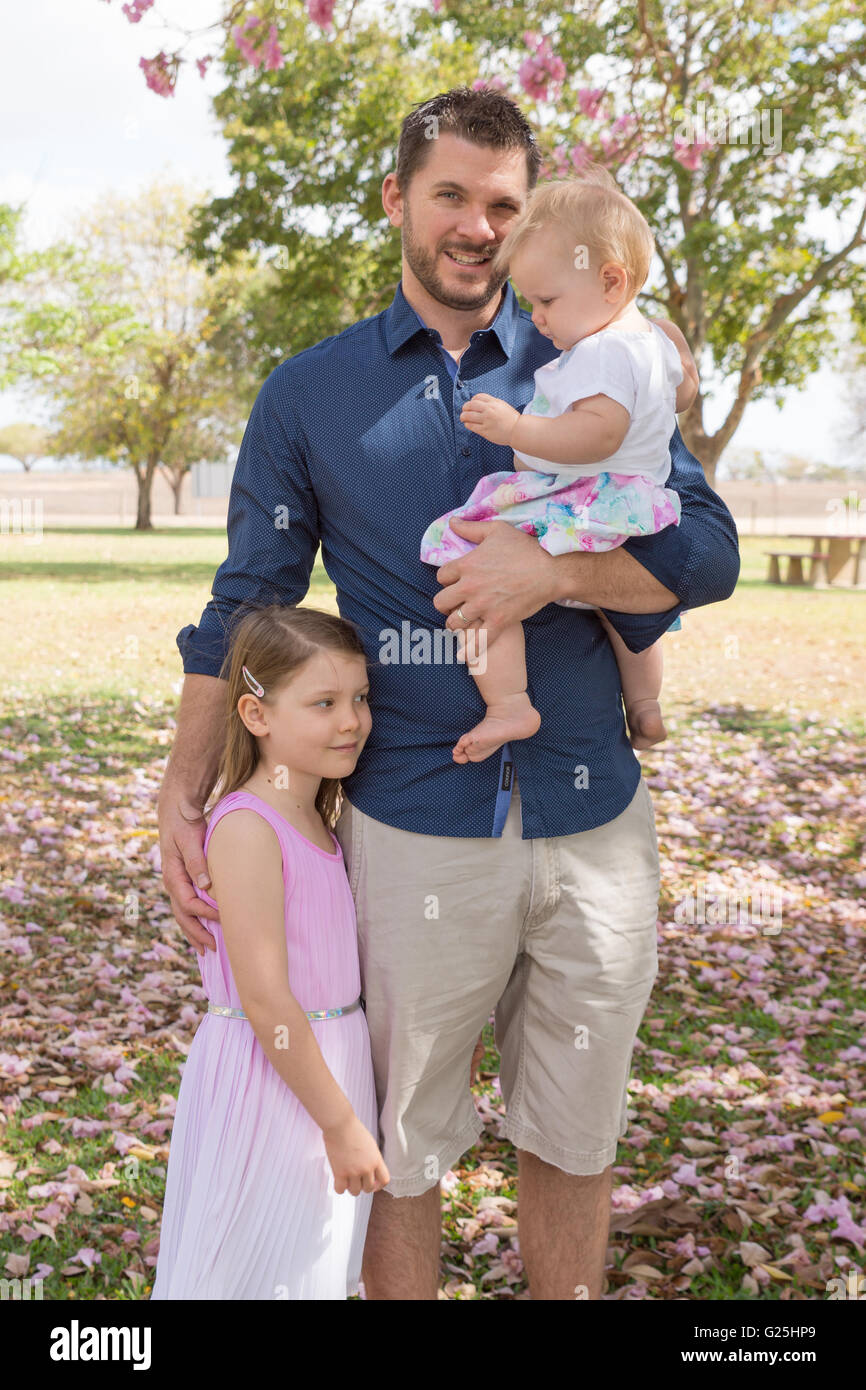 Father with two girls, holding baby girl Stock Photo