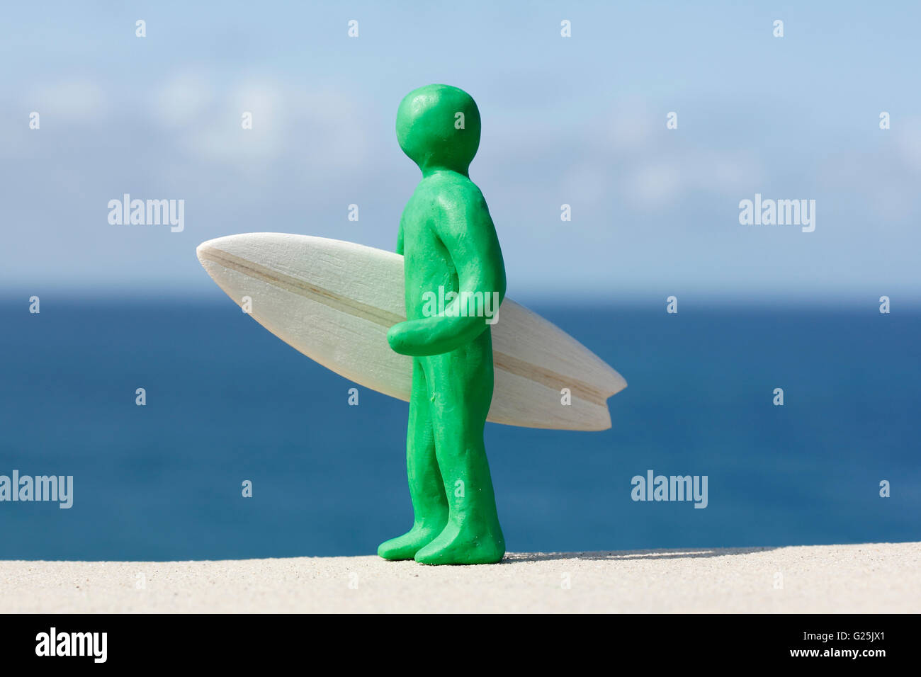 Plasticine Person and Balsa Surfboard Stock Photo