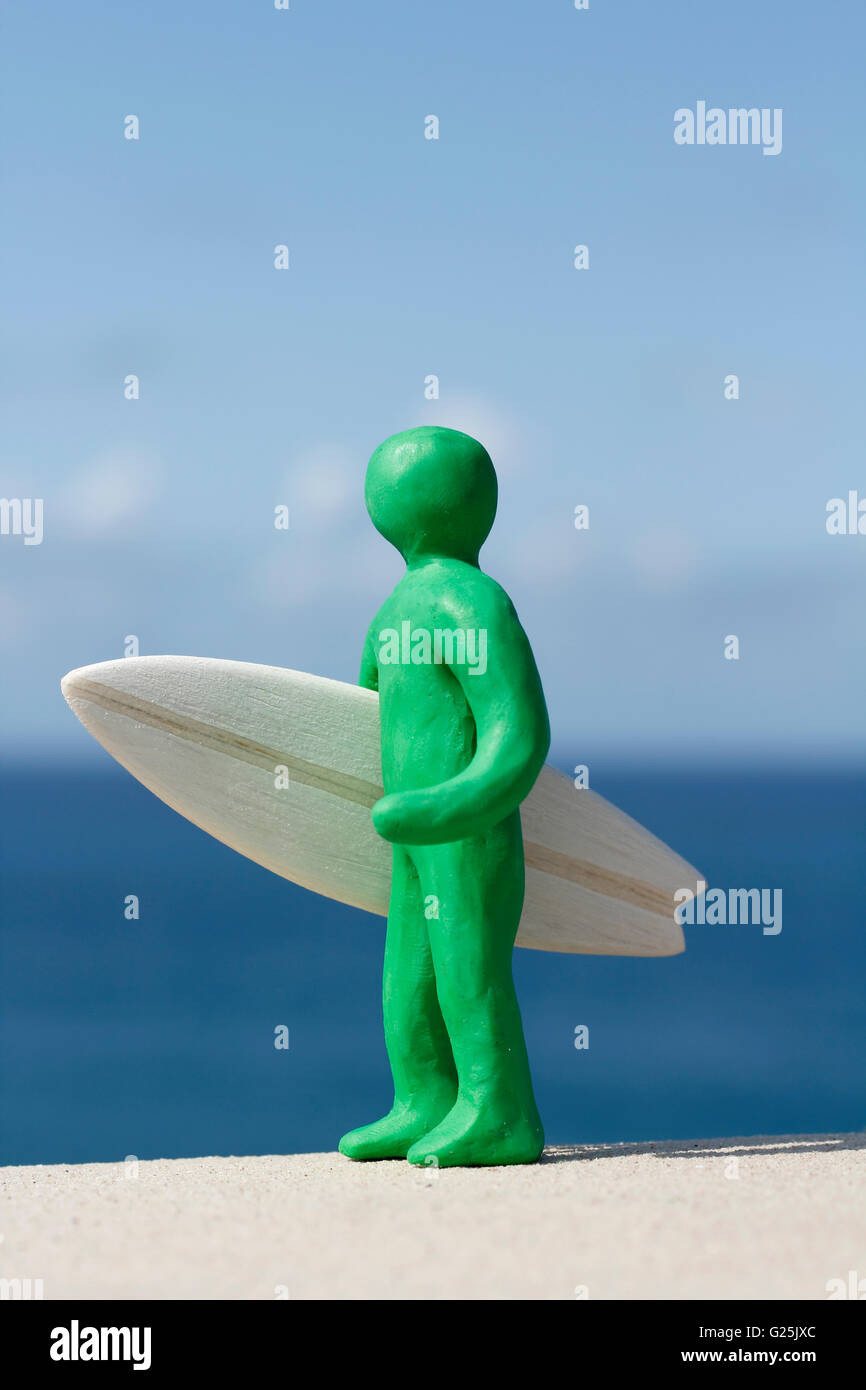 Plasticine Person and Balsa Surfboard Stock Photo