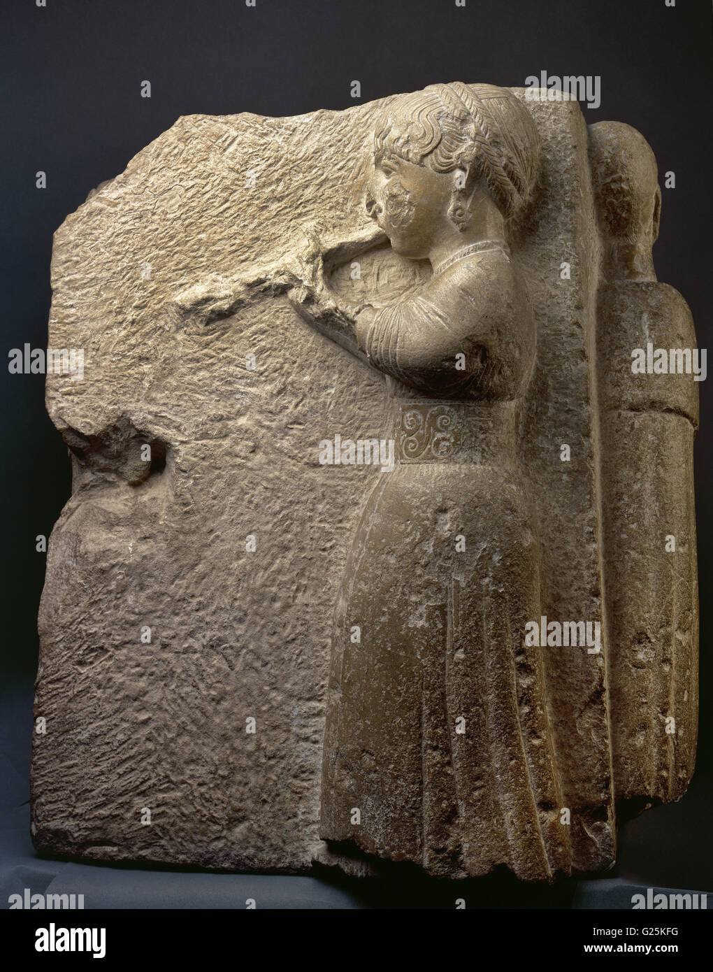 Iberian frieze relief depicting a woman or auletris dressed with tunic tied at the waist  playing a flute named aulos. In the hair, double braid around the head. From Osuna (Sevilla province, Andalusia). 3rd century - 2nd century BC. National Archaeological Museum. Madrid. Spain. Stock Photo