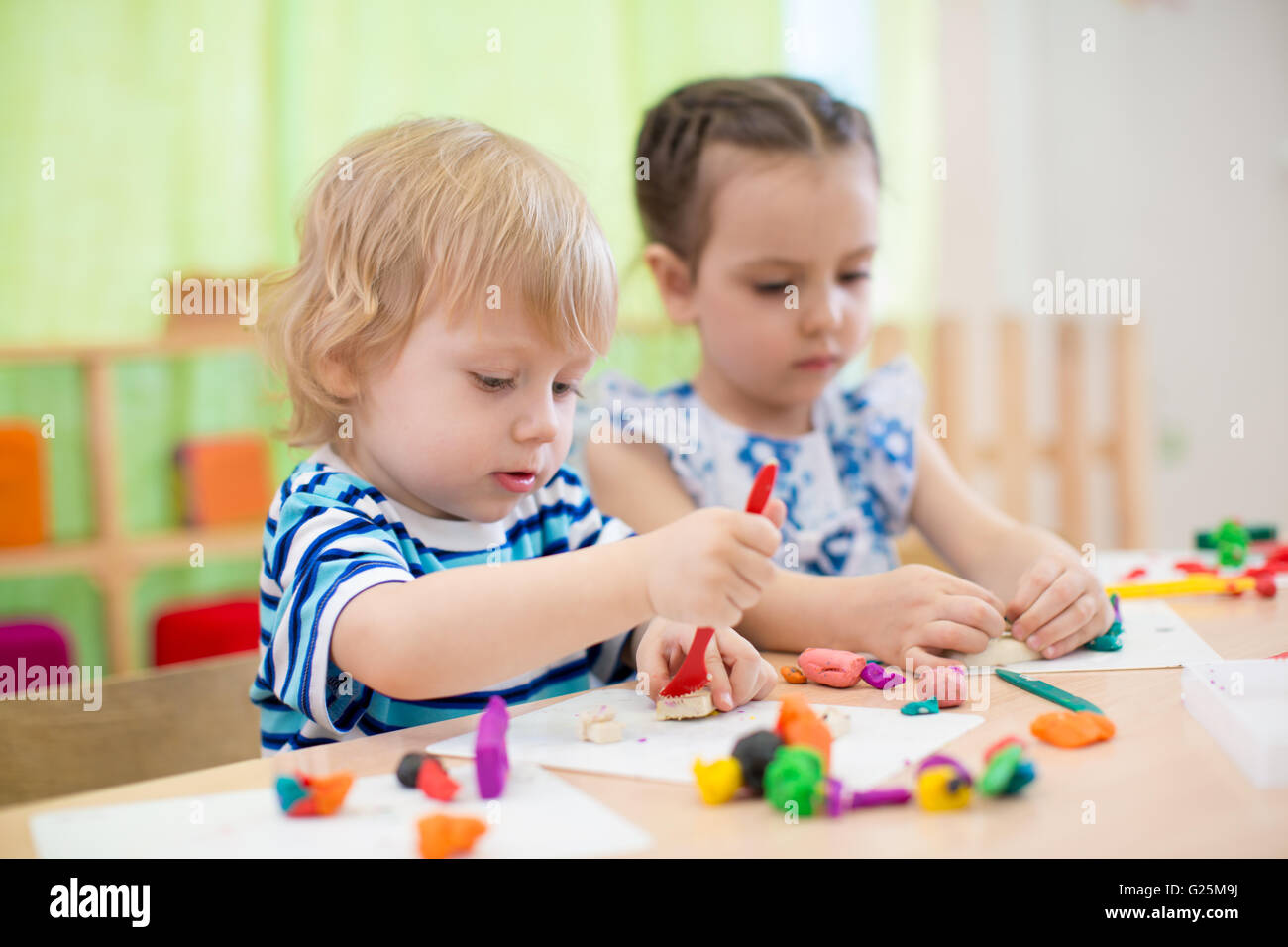 two kids doing arts and crafts in day care centre Stock Photo