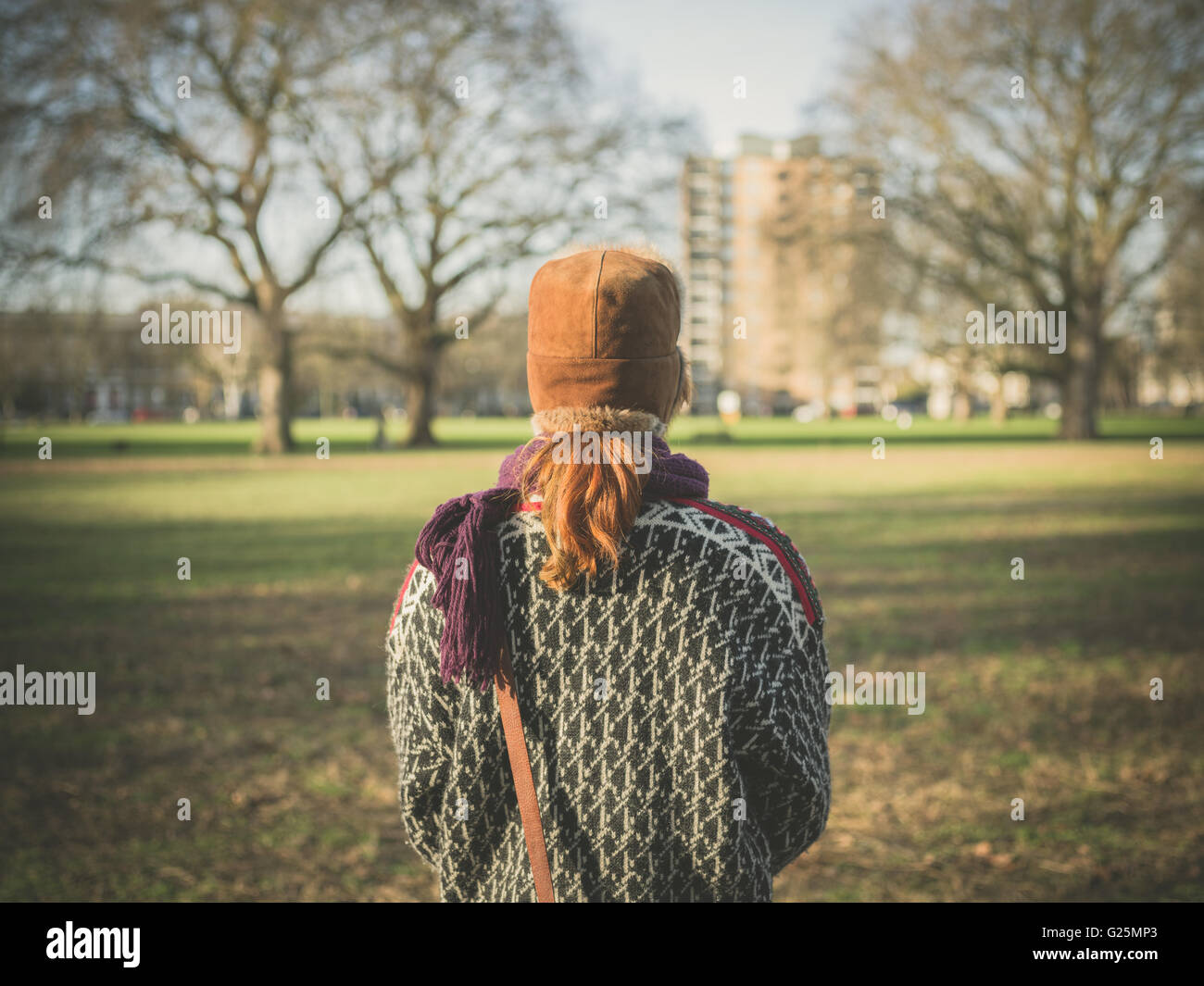 Woman alone walking winter park hi-res stock photography and images - Alamy