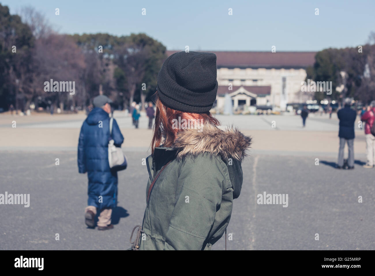 A young woman is walking in Ueno park in Tokyo Stock Photo