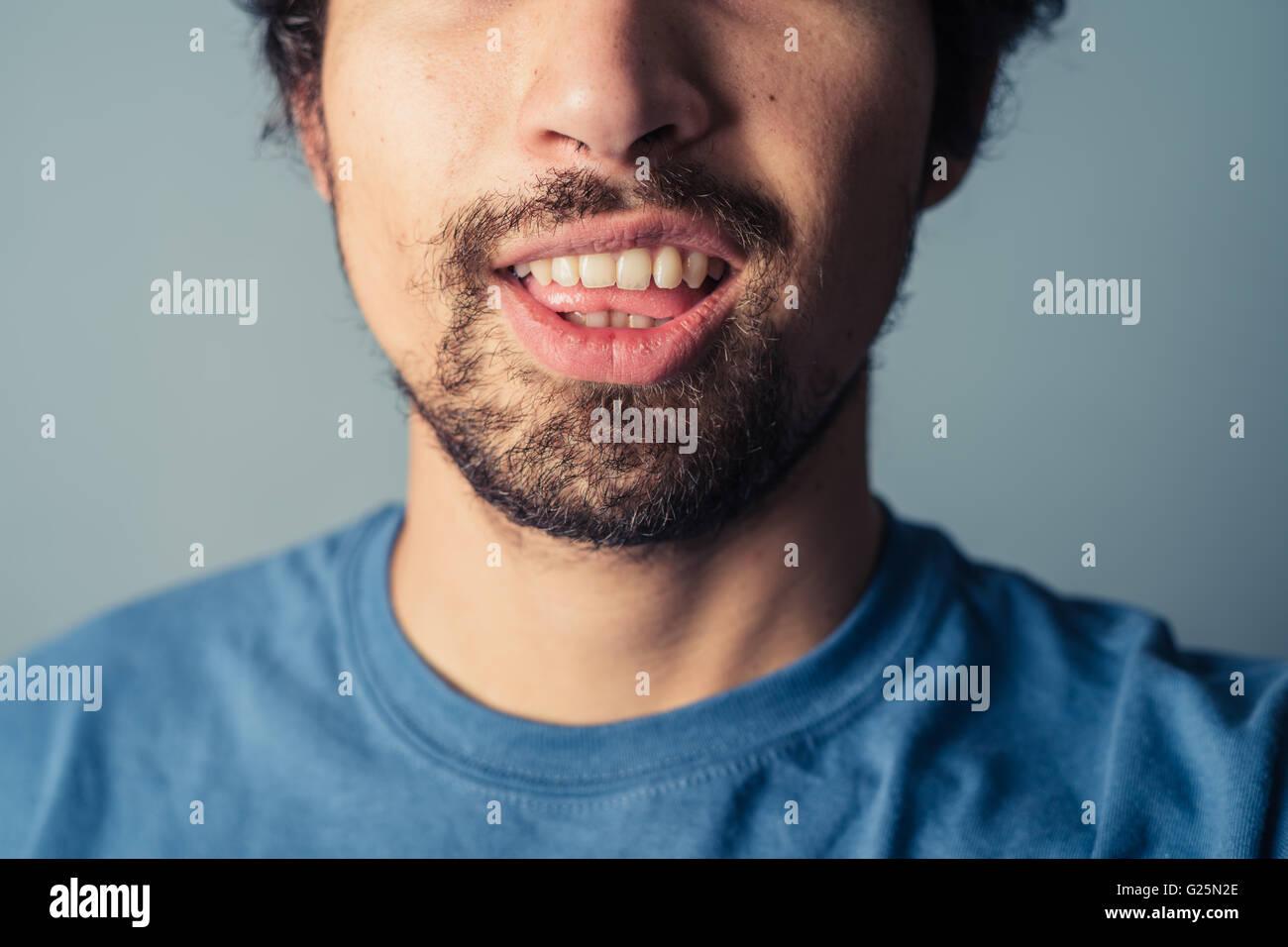 A young man with a beard is pulling silly faces Stock Photo