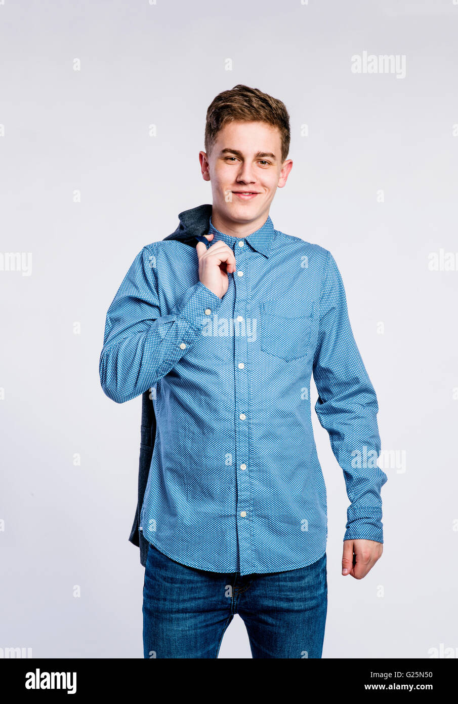 Boy in jeans and shirt, young man, studio shot Stock Photo Alamy