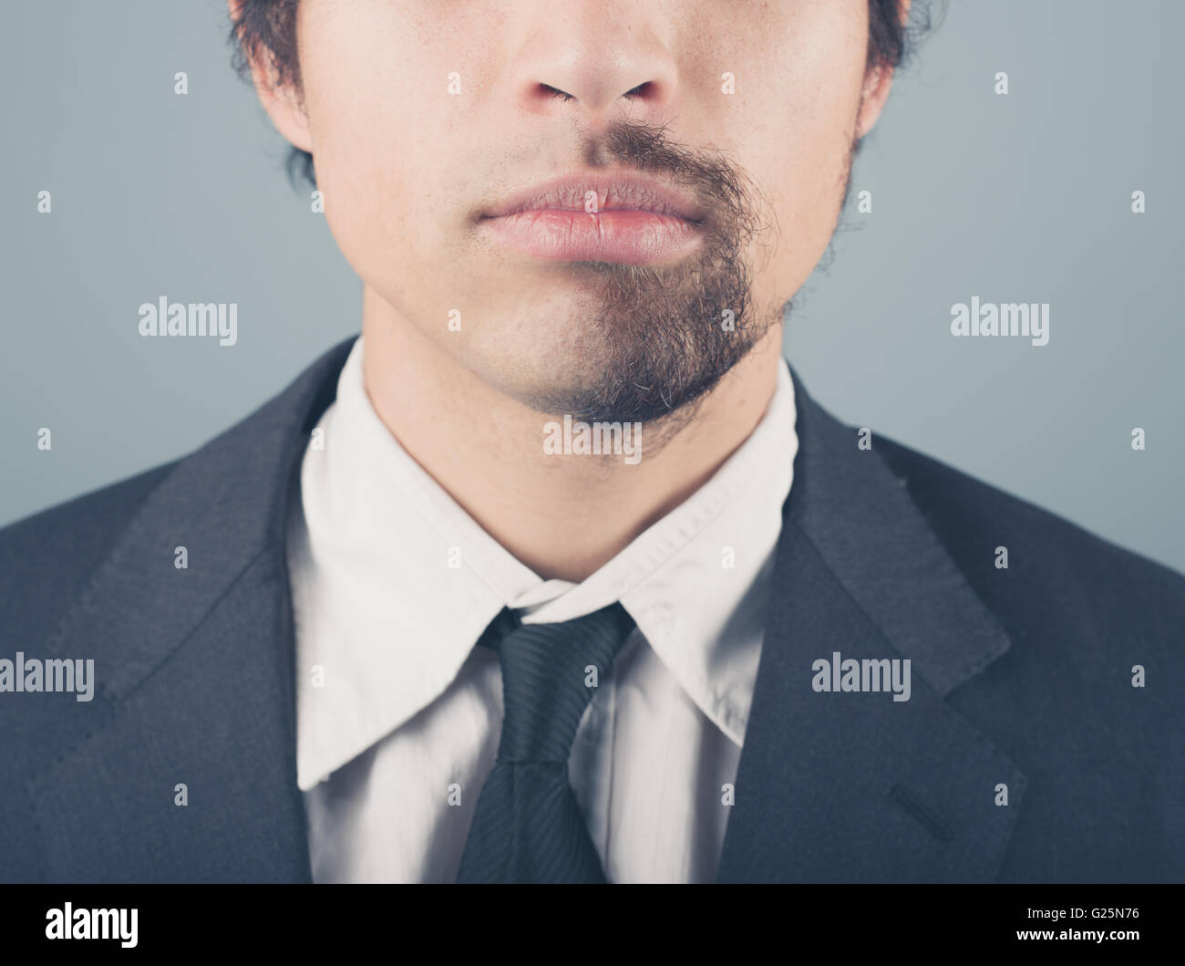 A young businessman with a half shaved beard Stock Photo