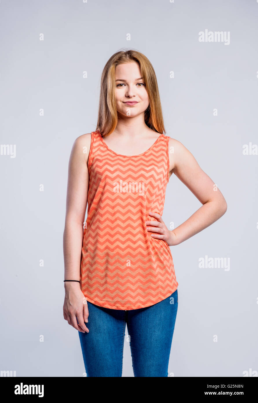 Girl in jeans and singlet, young woman, studio shot Stock Photo - Alamy