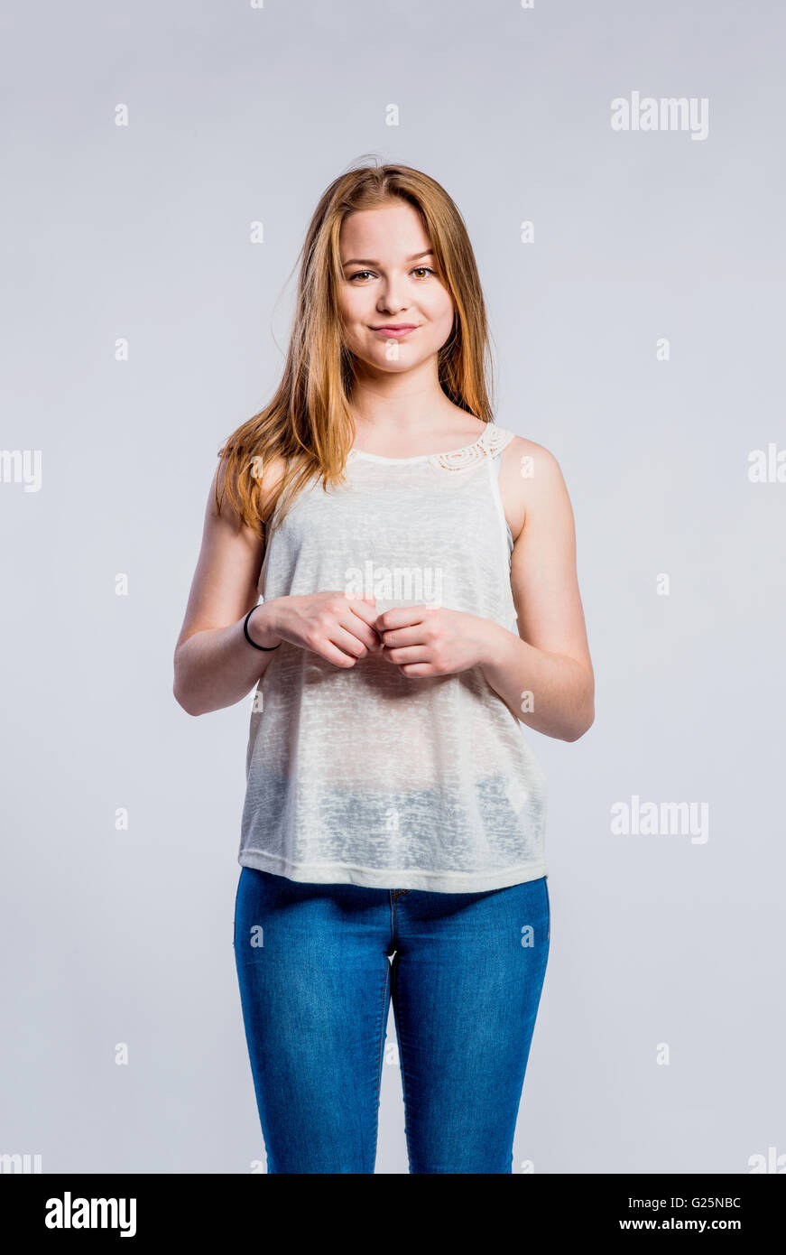 Girl in jeans and singlet, young woman, studio shot Stock Photo