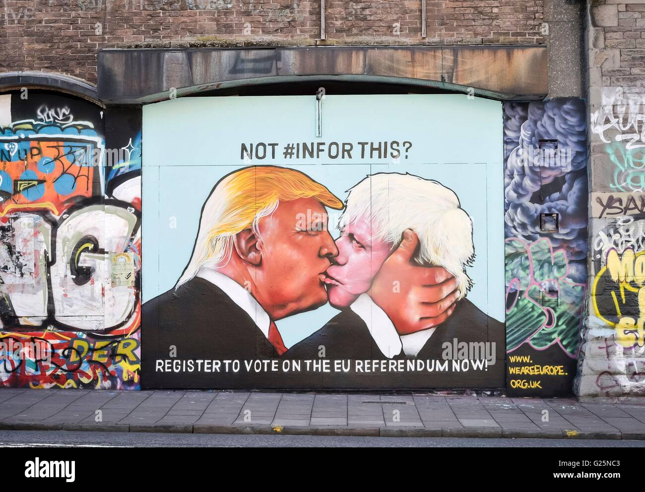 A graffiti mural of Donald Trump and Boris Johnson kissing, sprayed on a disused building in the Stokes Croft area of Bristol. Stock Photo