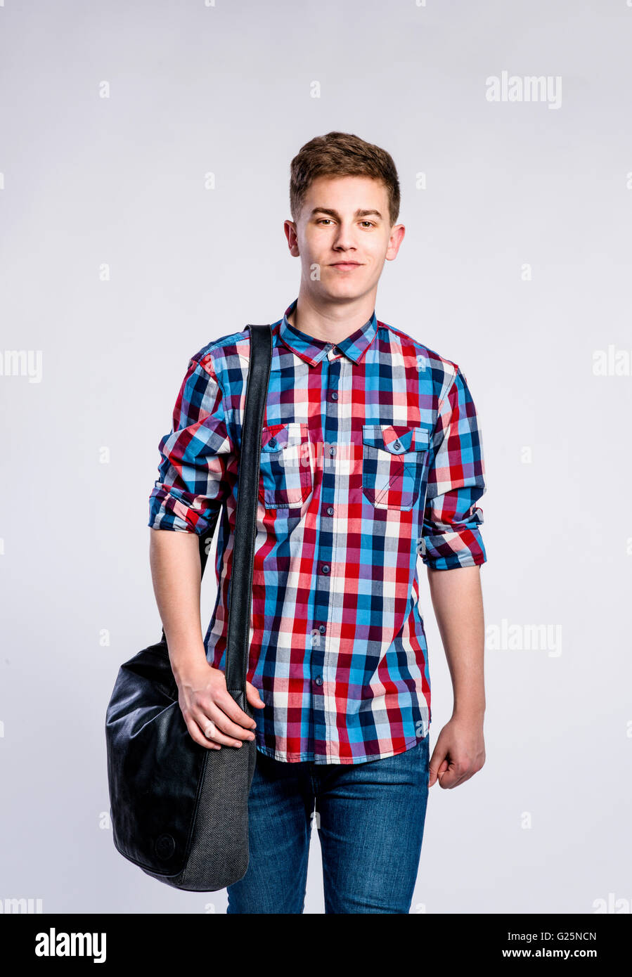 Boy in jeans and shirt, young man, studio shot Stock Photo Alamy