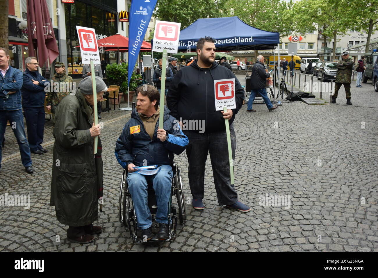 some people demonstrate against the advertising of the German Bundeswehr on the Friedensplatz in Bonn, Germany Stock Photo