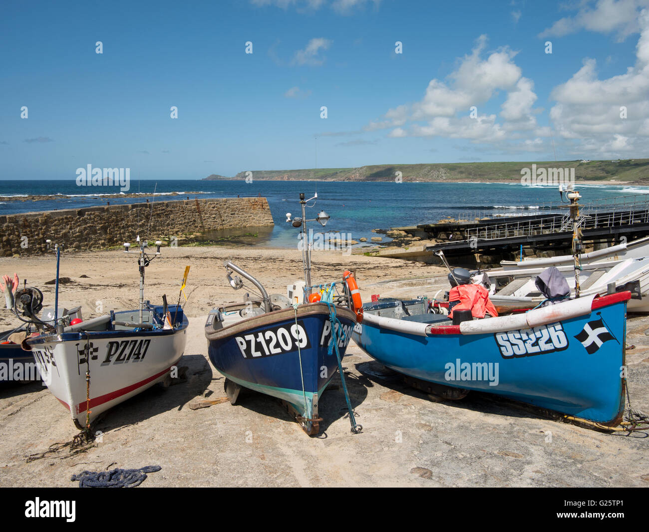 Cornish fishing boats in Sennen Cove harbour at low tide, Cornwall England UK. Stock Photo