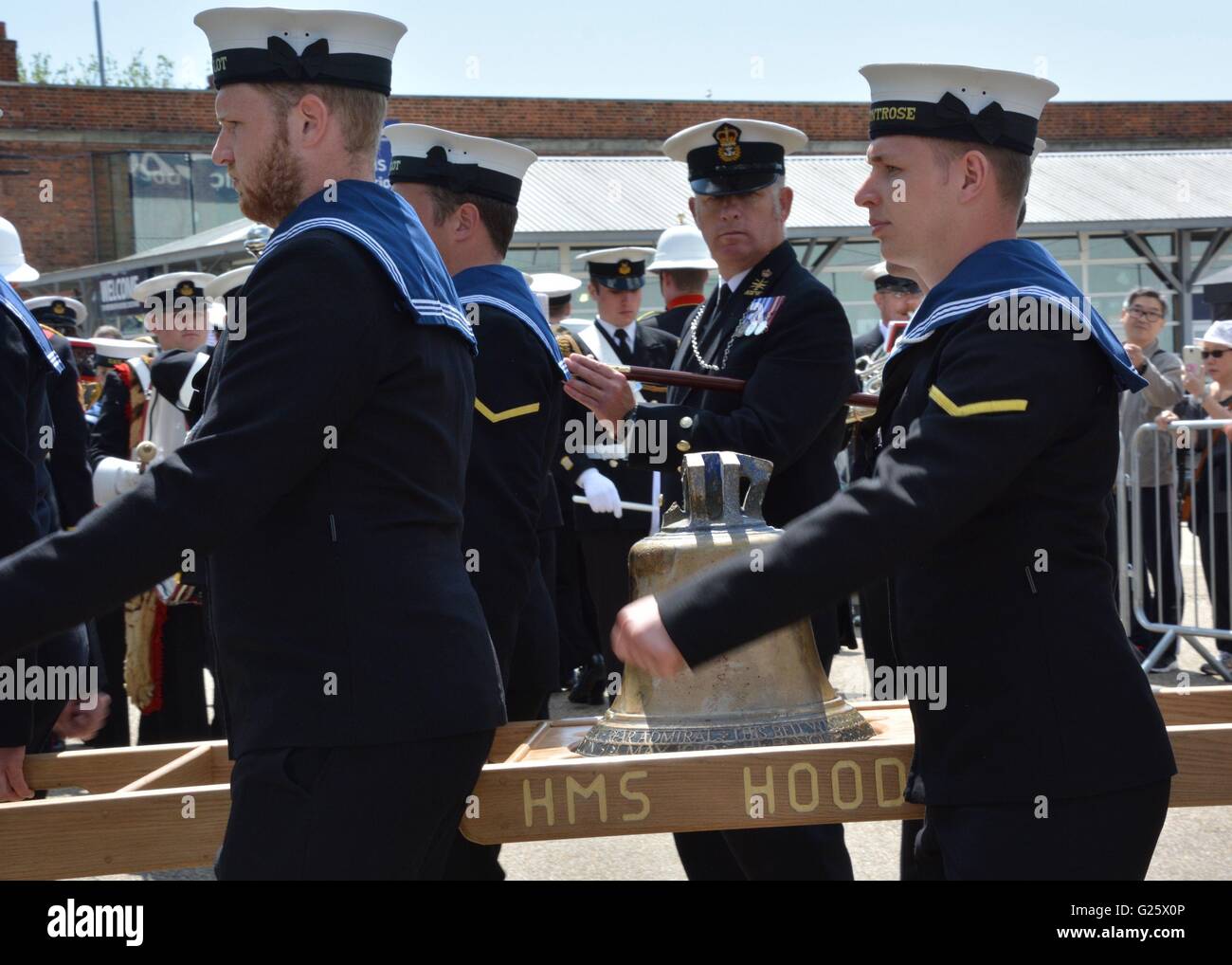 The bell from HMS Hood is carried by a Royal Navy guard at Portsmouth Historic Dockyard after it was unveiled by the Princess Royal to mark the 75th anniversary of the Royal Navy's largest loss of life from a single vessel. Stock Photo