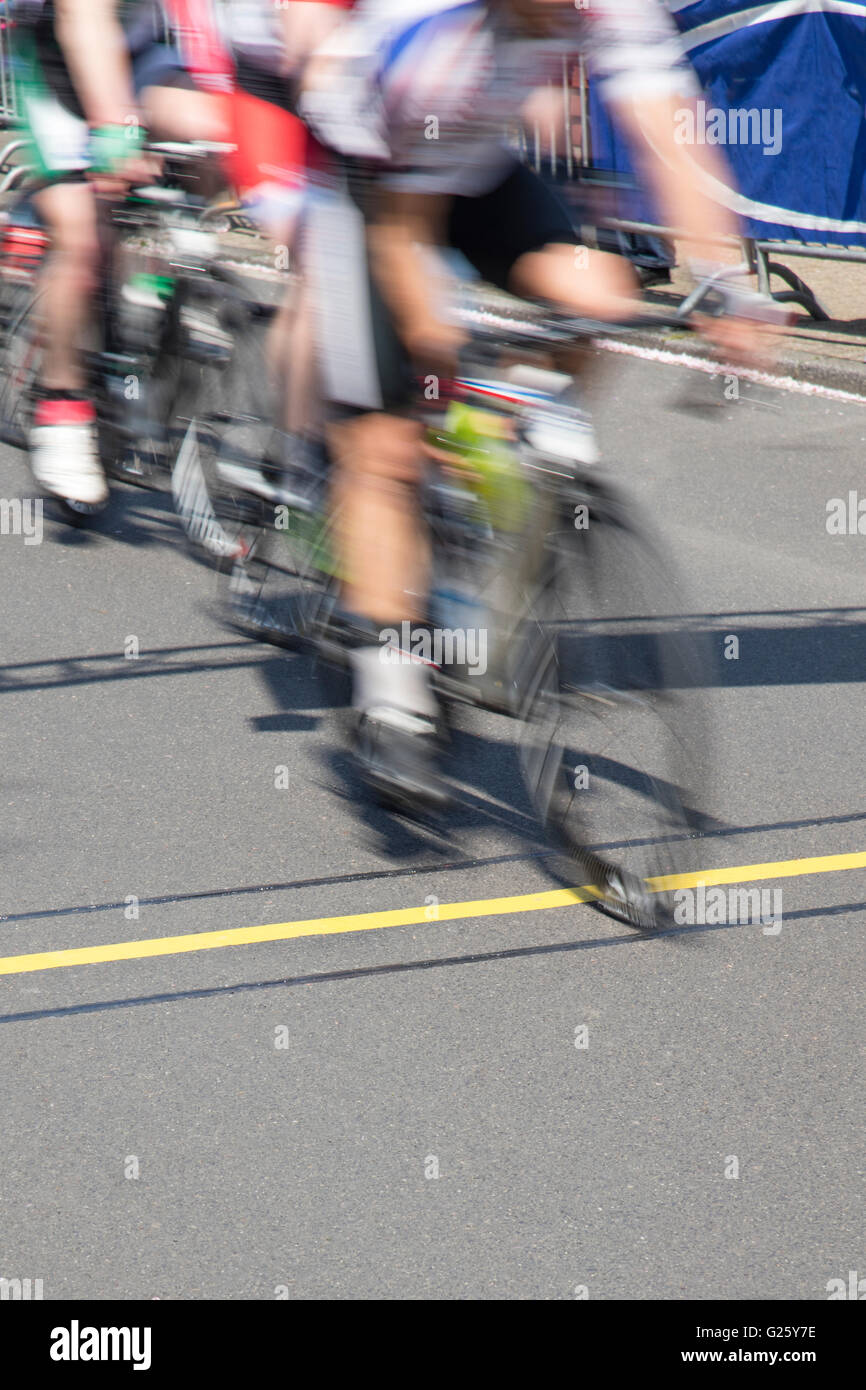 Blurred cyclist, due to speed, reaching the finishing line on a race ...