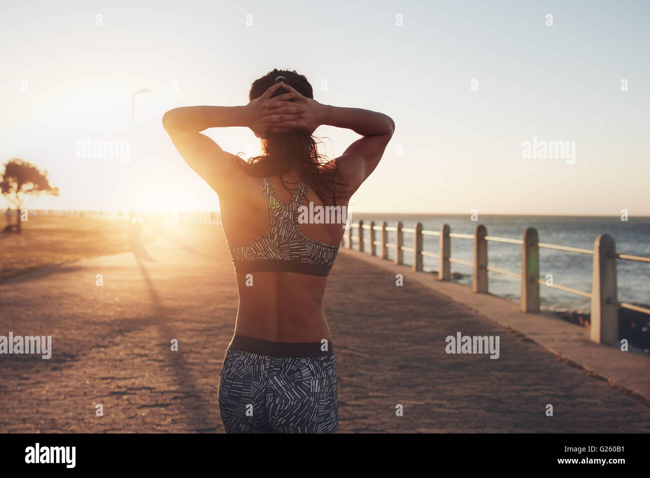 Athlete walking hands on head rear view hi-res stock photography and ...