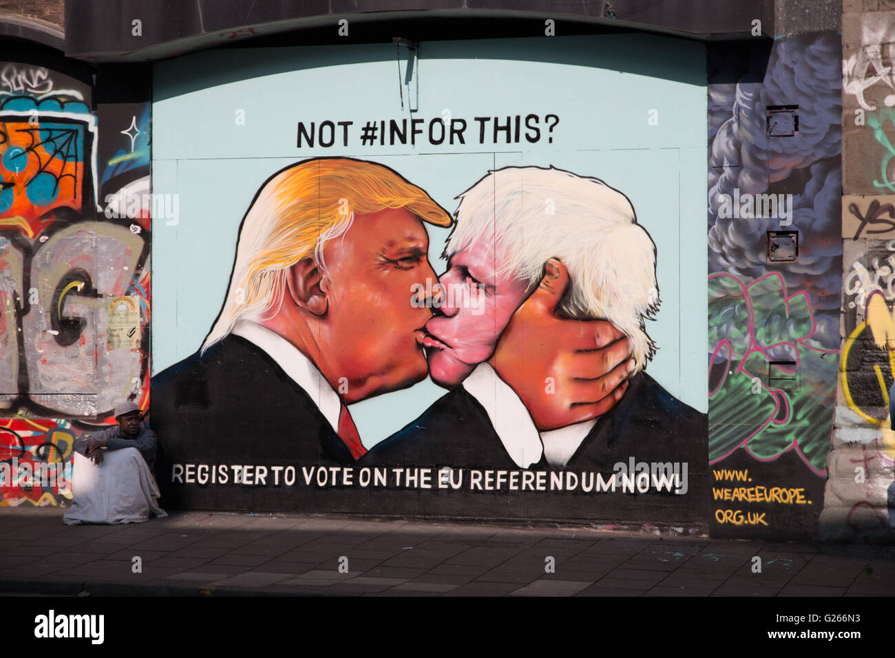 Satirical street art showing Donald Trump kissing Boris Johnson, to encourage people to vote in the 2016 EU referendum. Stock Photo