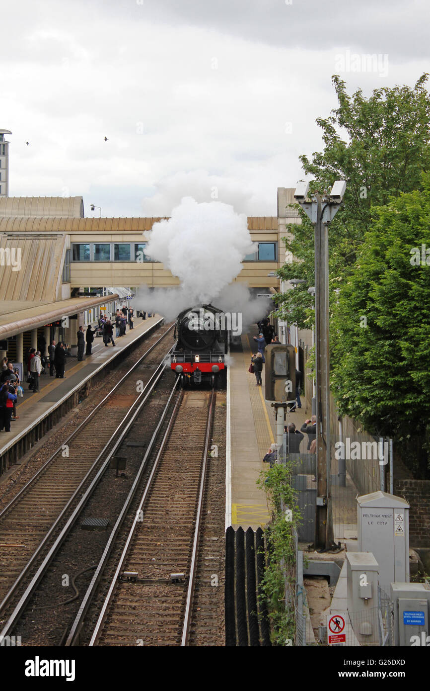 Feltham, Hounslow, London, UK. 25th May 2016. The Flying Scotsman billowing steam passes through Feltham station, London, UK. This was on the outward leg of a journey from London Victoria south to Guildford, across the Surrey Hills and returning to London via Croydon. Credit:  Julia Gavin UK/Alamy Live News Stock Photo