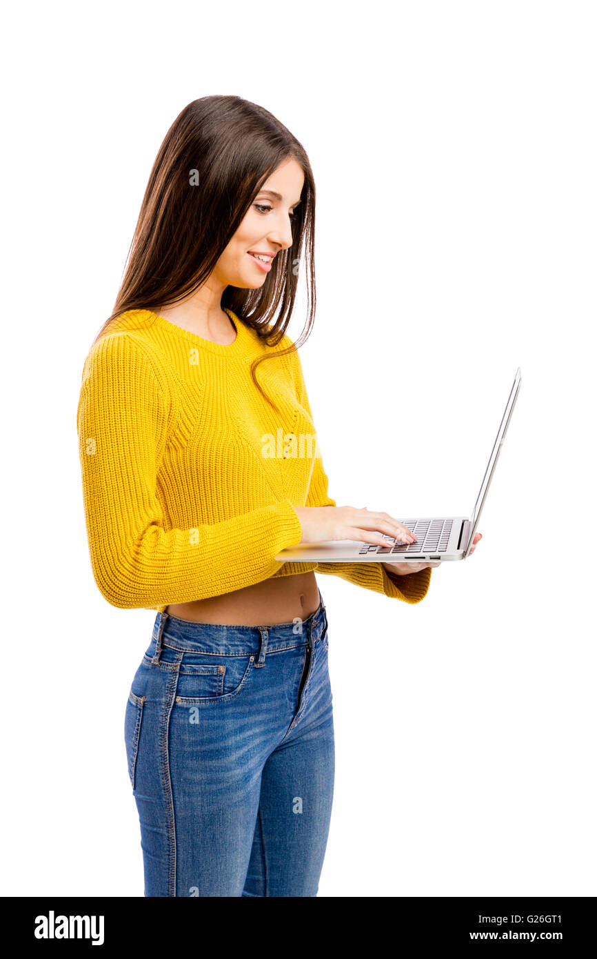 Beautiful and happy girl working with a laptop, isolated over white ...