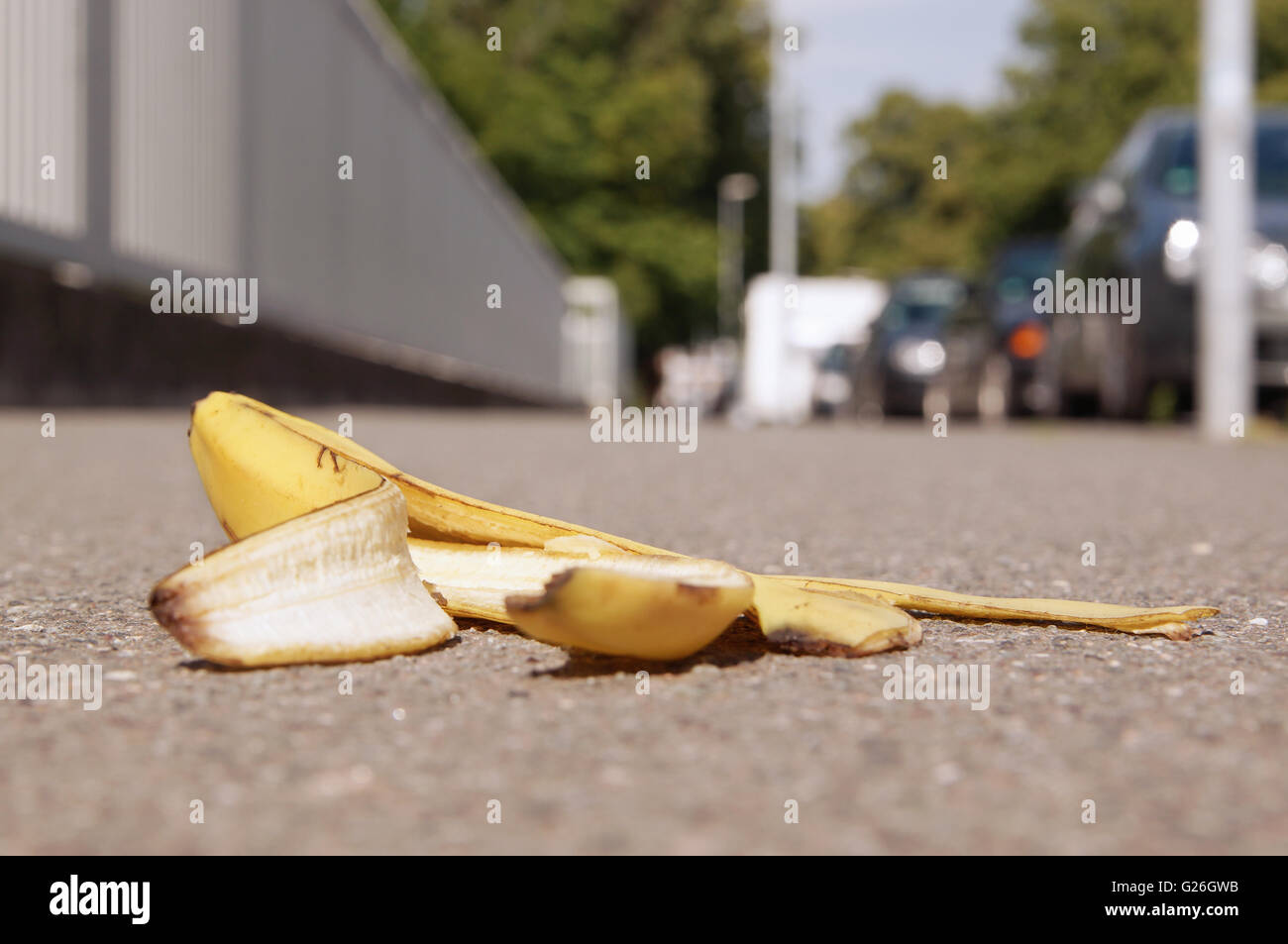 discarded banana skin on pavement Stock Photo