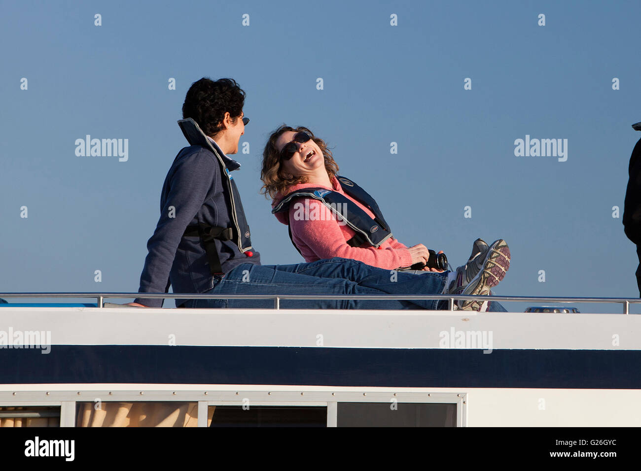 Two women laughing and relaxing on a Norfolk Broads cruiser Stock Photo