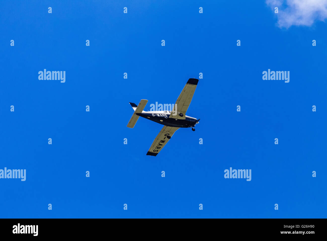 Piper PA-28 G-WARS flying, in an almost cloudless blue sky, over Elstree Airfield, Hertfordshire, UK, prior to landing. Stock Photo