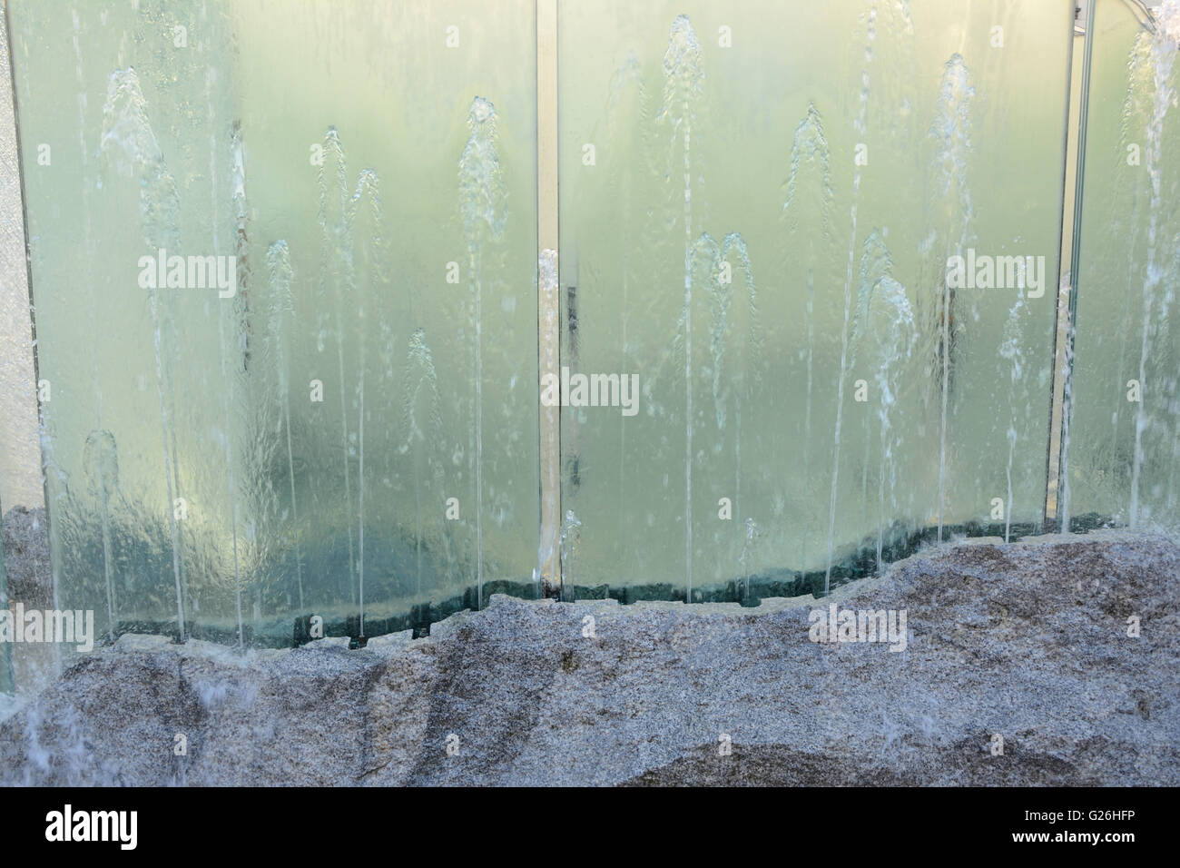 Water splattering in glass fountain - background. Stock Photo