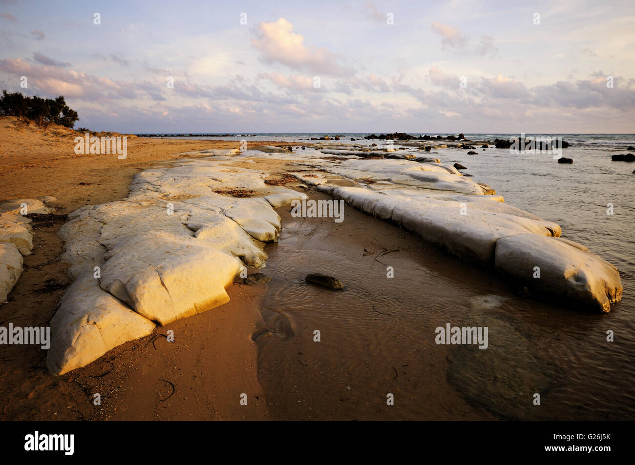 Deserted sandy and rocky beach near Realmonte at sunset, Sicily, Italy Stock Photo