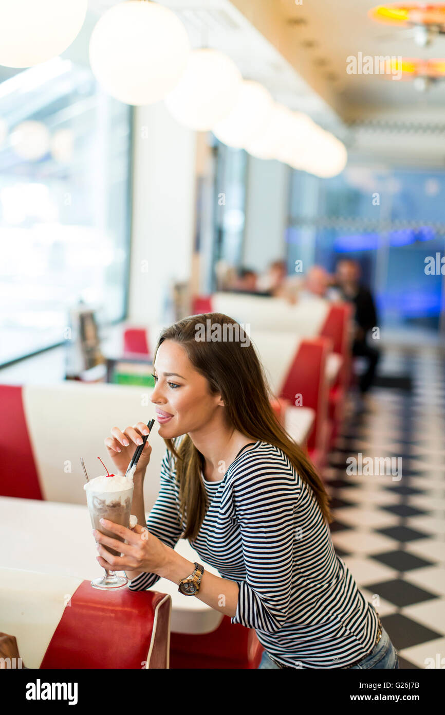 Woman with the milkshake at the diner Stock Photo
