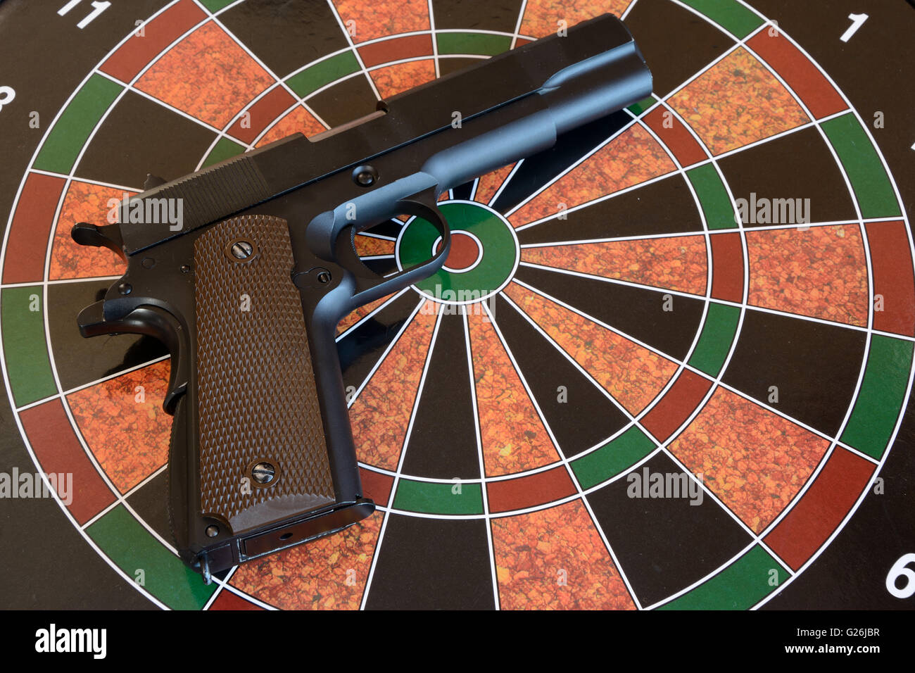 Airsoft gun on target dartboard Stock Photo Alamy