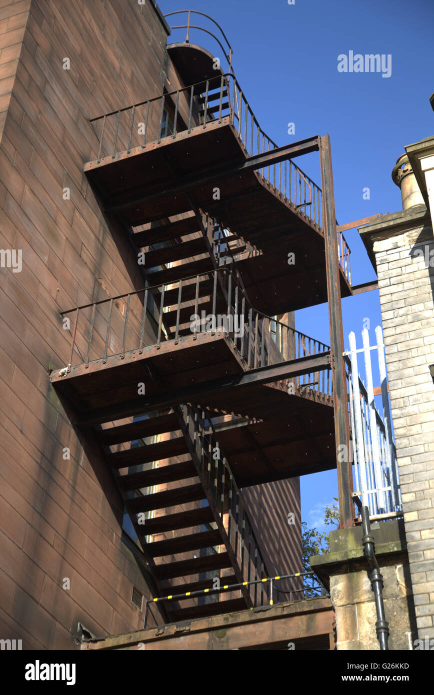 Old iron fire escape on red sandstone building from below Glasgow, Scotland, UK. Stock Photo