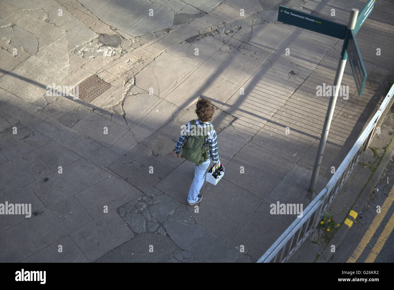 boy man walking with pack of beer viewed from above, Glasgow, Scotland, UK. Stock Photo