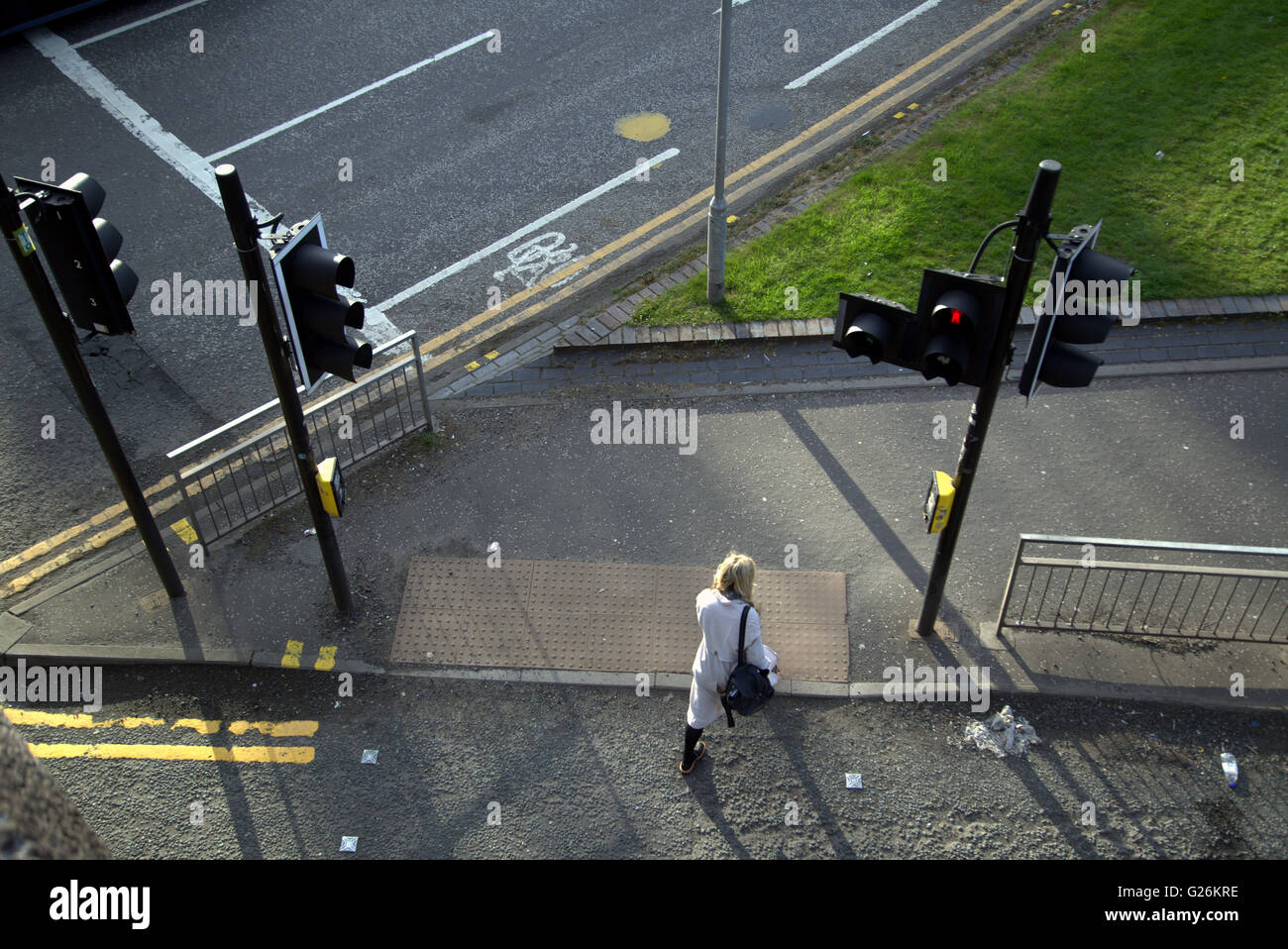 Woman walking at traffic lights viewed from above, Glasgow, Scotland, UK. Stock Photo