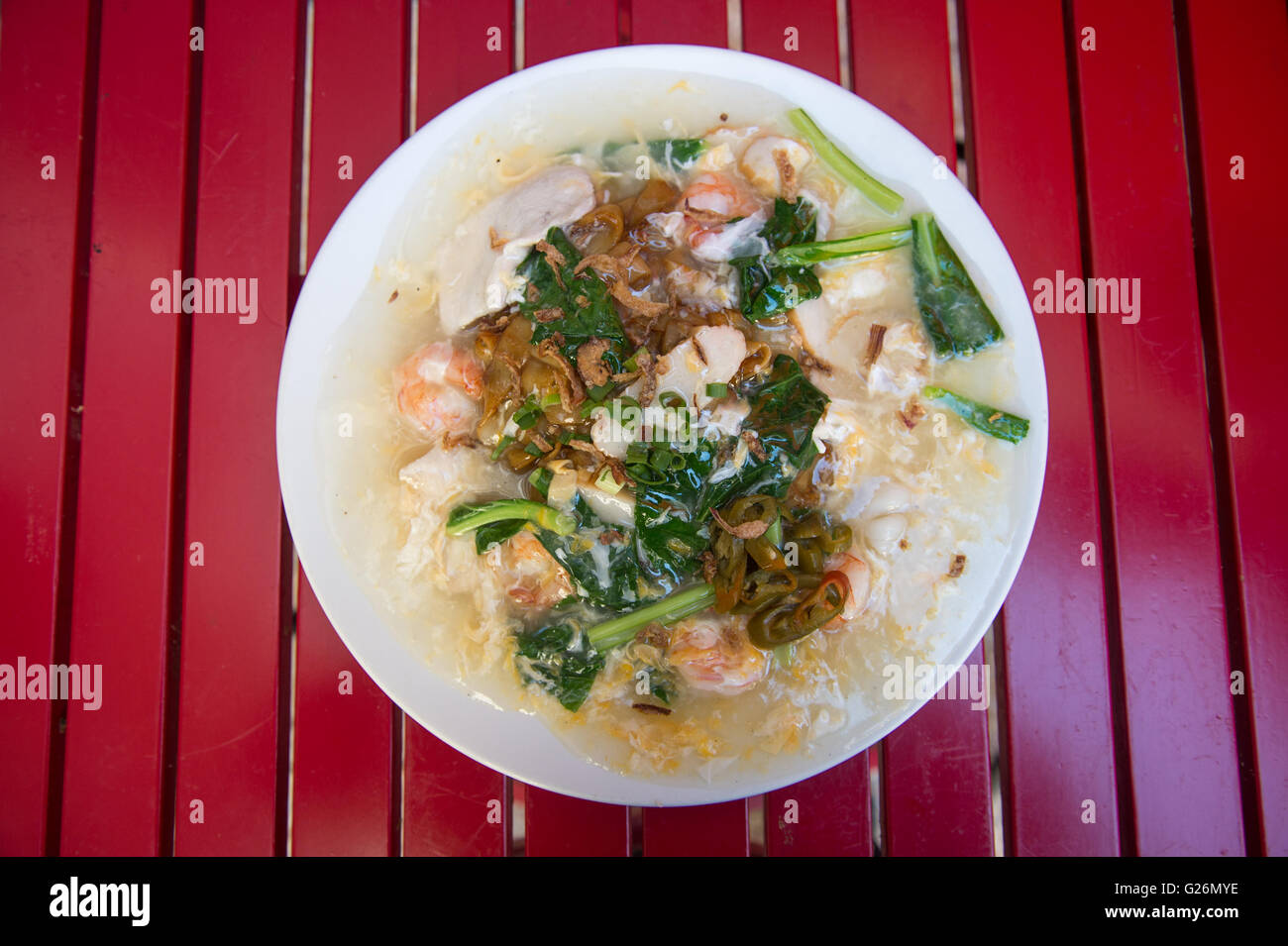 Flat rice noodles wok fried with seafood, chicken, and vegetables
